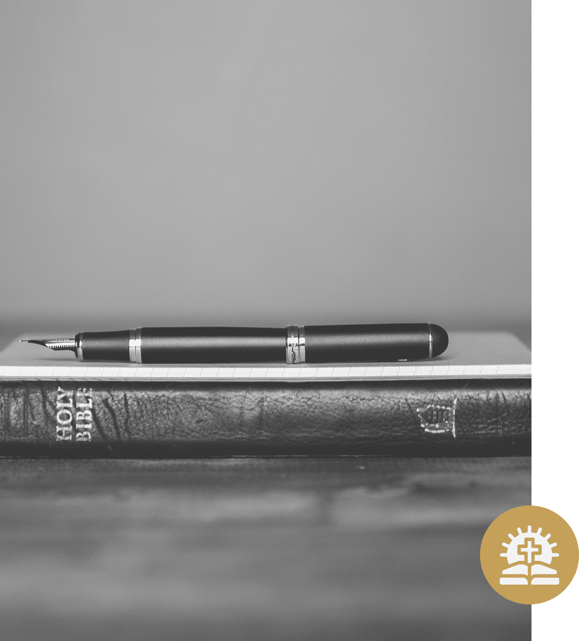 Pen resting on a Holy Bible.